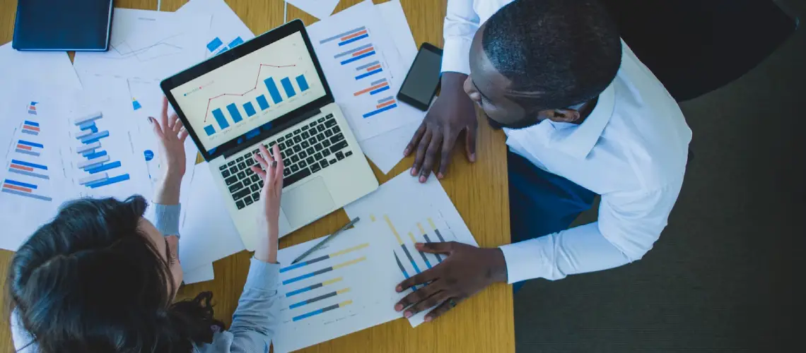 Business advisor reviewing financial data for business valuation Perth in office setting